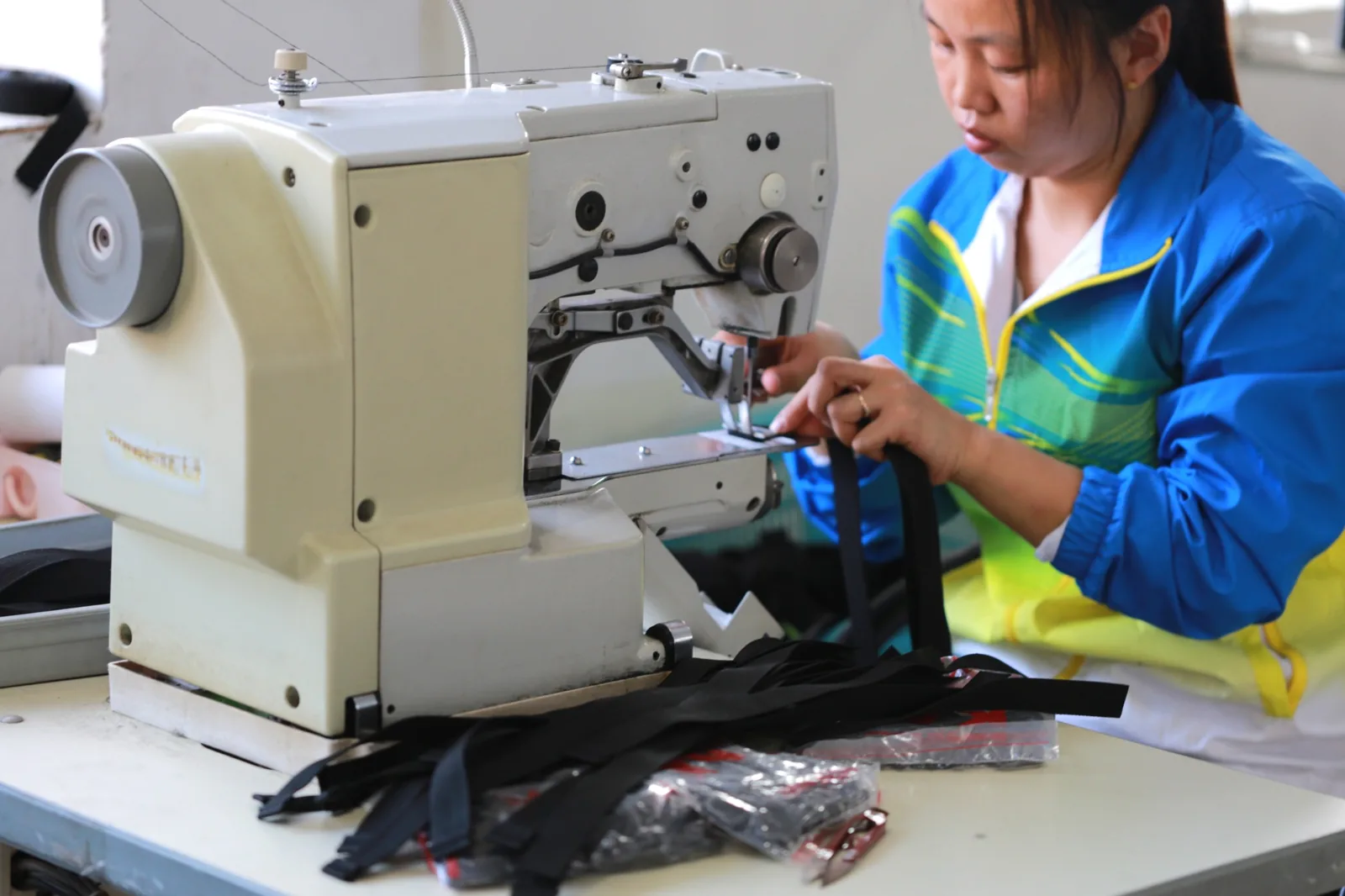 Worker sewing custom bag